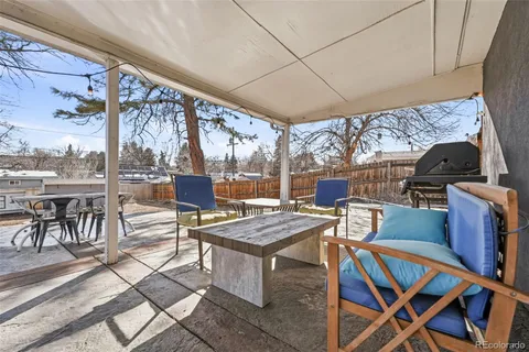 a view of a patio with a dining table and chairs