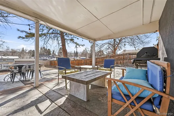 a view of a patio with a dining table and chairs