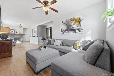 a living room with furniture and a wooden floor
