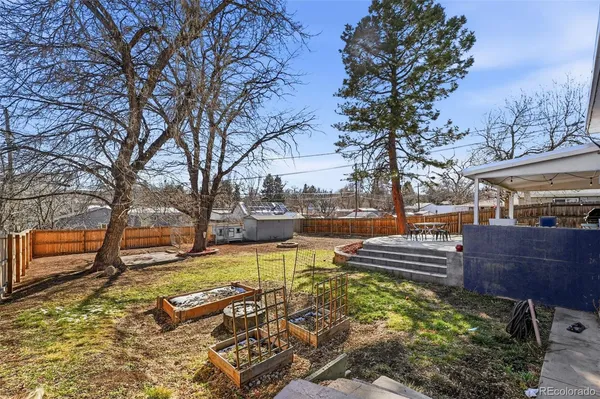 a view of a yard with wooden fence