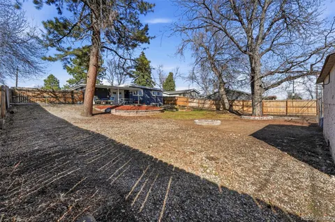a view of a yard with trees in the background
