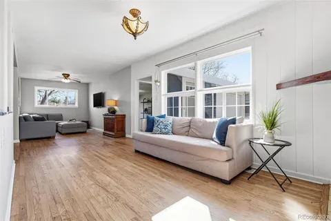 a living room with furniture and a wooden floor