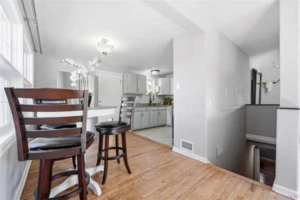 a kitchen with stainless steel appliances kitchen island granite countertop a refrigerator and a stove top oven