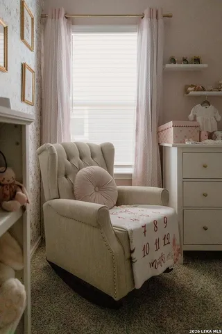 a bedroom with furniture and a window