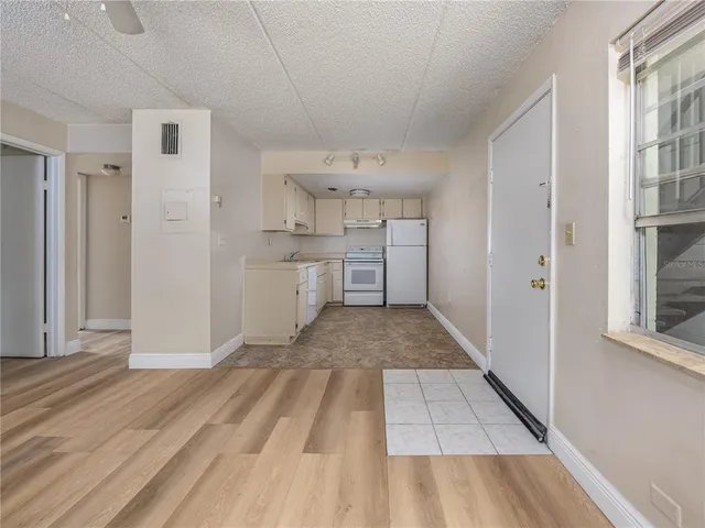 a kitchen with a sink and refrigerator
