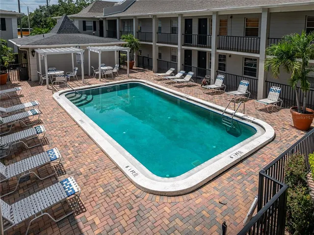 a swimming pool with outdoor seating and yard