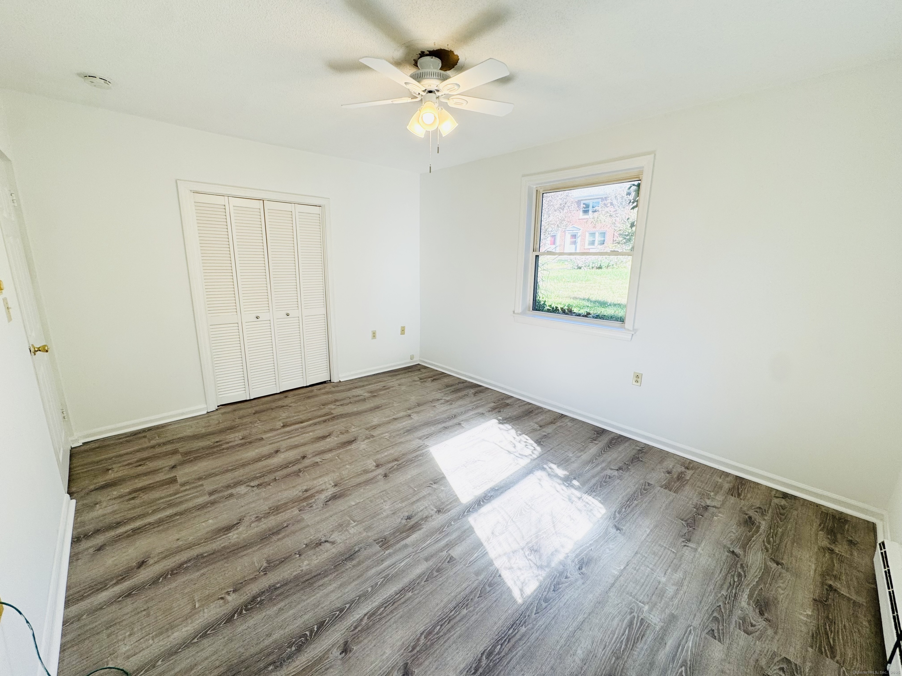 107 Niles Hill Road, Unit A New London, CT 06320 - Photo 14 of 22 a view of a room with wooden floor and a ceiling fan