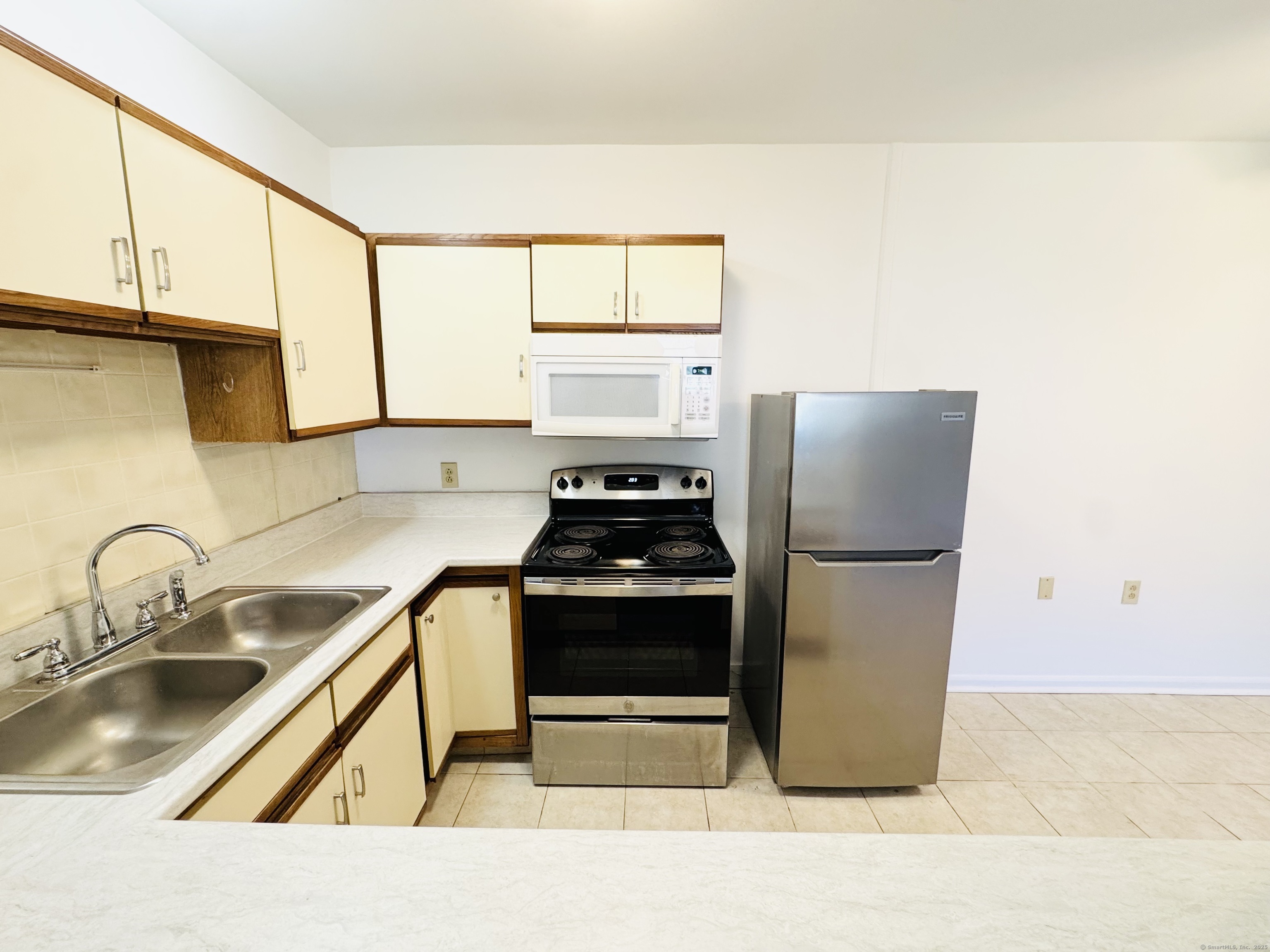 107 Niles Hill Road, Unit A New London, CT 06320 - Photo 8 of 22 a kitchen with a stove a sink and a refrigerator