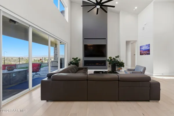 a kitchen with a refrigerator a stove a dining table and chairs with wooden floor