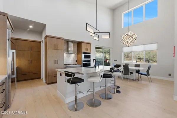 a dining room with furniture a rug and a painting