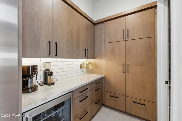 a kitchen with stainless steel appliances granite countertop a sink and a refrigerator