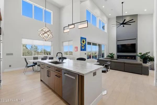 a kitchen with stainless steel appliances granite countertop a refrigerator and a white cabinets