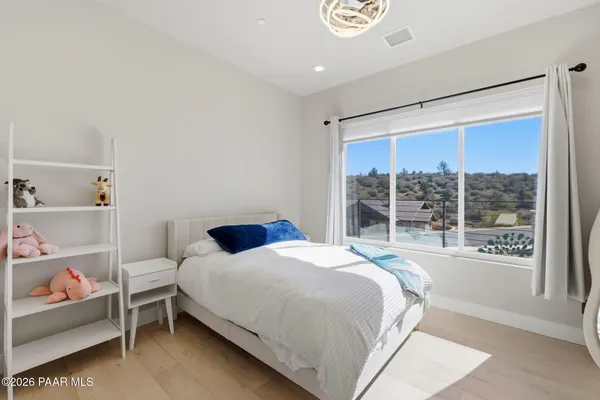 a bathroom with a granite countertop sink a toilet and mirror