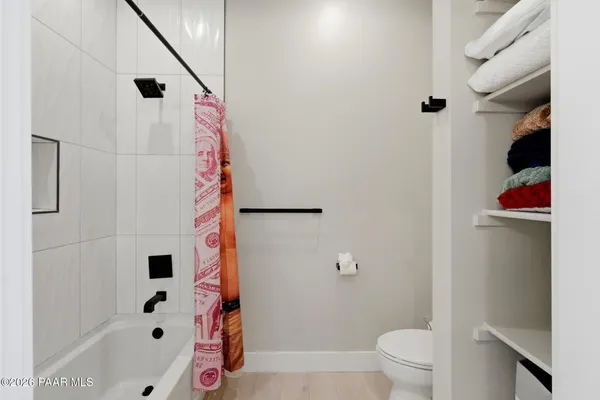 a room with furniture pool table flat screen tv and a large window