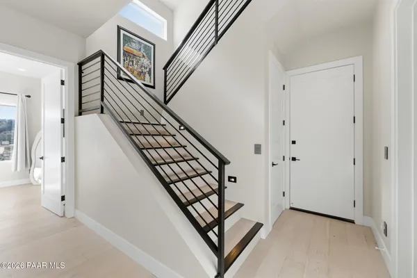 a bathroom with a granite countertop sink mirror and toilet