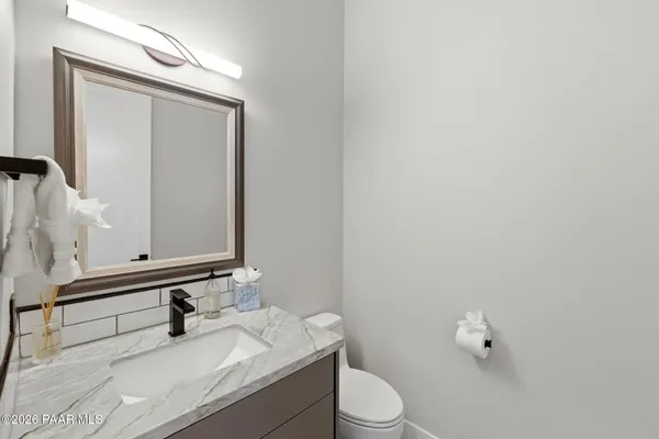 a view of a porch with chairs and backyard