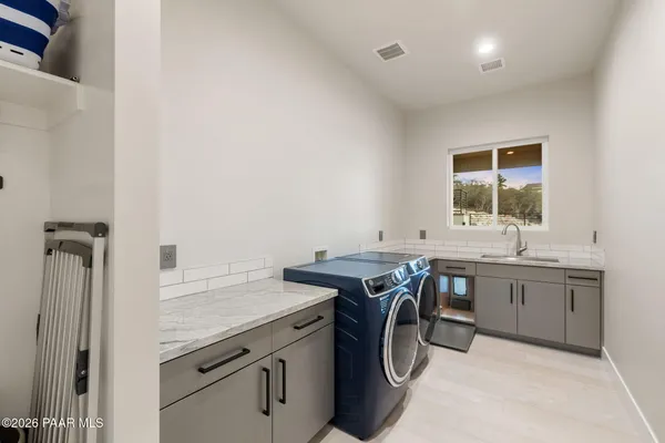 a view of a patio with table and chairs potted plants with wooden floor and fence