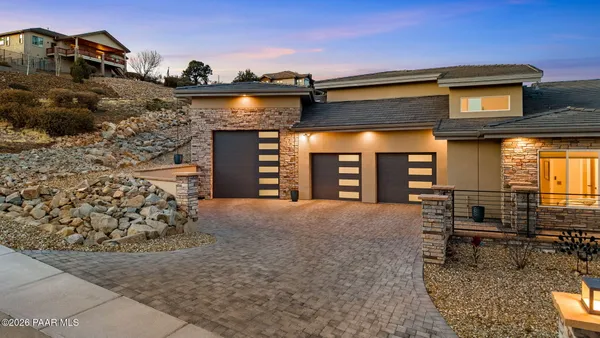 a view of a terrace with furniture and a garden