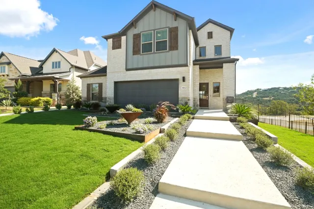 a front view of a house with garden