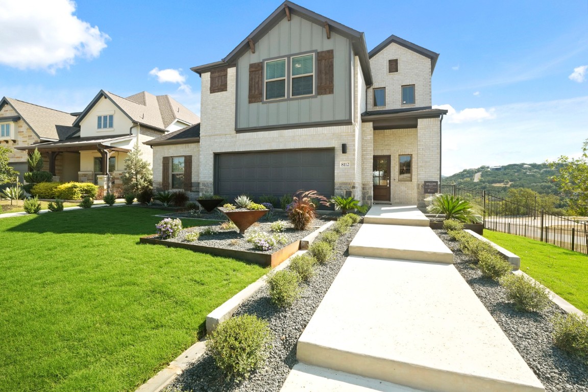 a front view of a house with garden