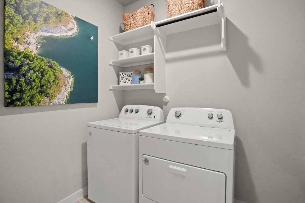 8112 Turning Leaf Circle Lago Vista, TX 78645 - Photo 12 of 29 a utility room with dryer and washer