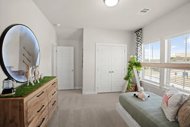 a spacious bedroom with bed and a windows