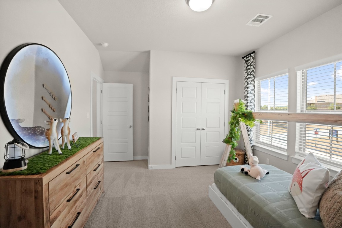 8112 Turning Leaf Circle Lago Vista, TX 78645 - Photo 16 of 29 a spacious bedroom with bed and a windows