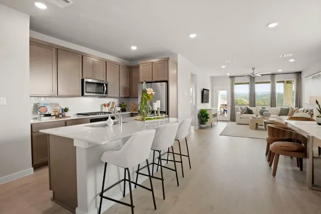 a kitchen with kitchen island wooden cabinets and stainless steel appliances