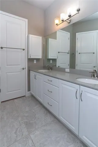 a bedroom with a bed and a mirror