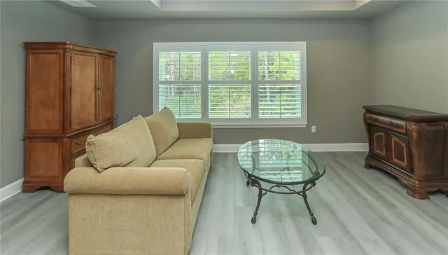 a view of a livingroom with an empty space and a window