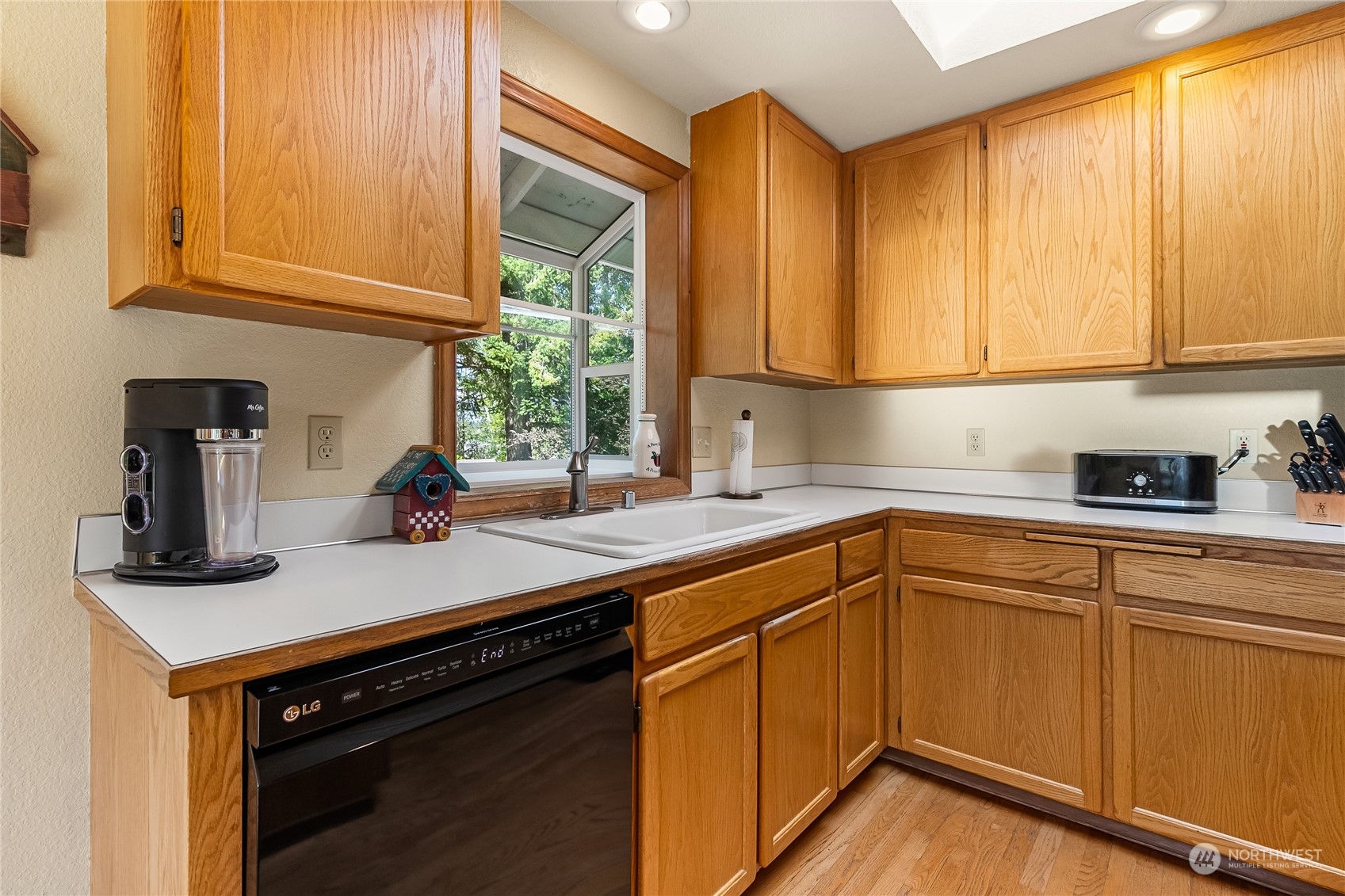 1388 Welling Road Bellingham, WA 98226 - Photo 13 of 40 a kitchen with stainless steel appliances granite countertop a sink a stove and a microwave