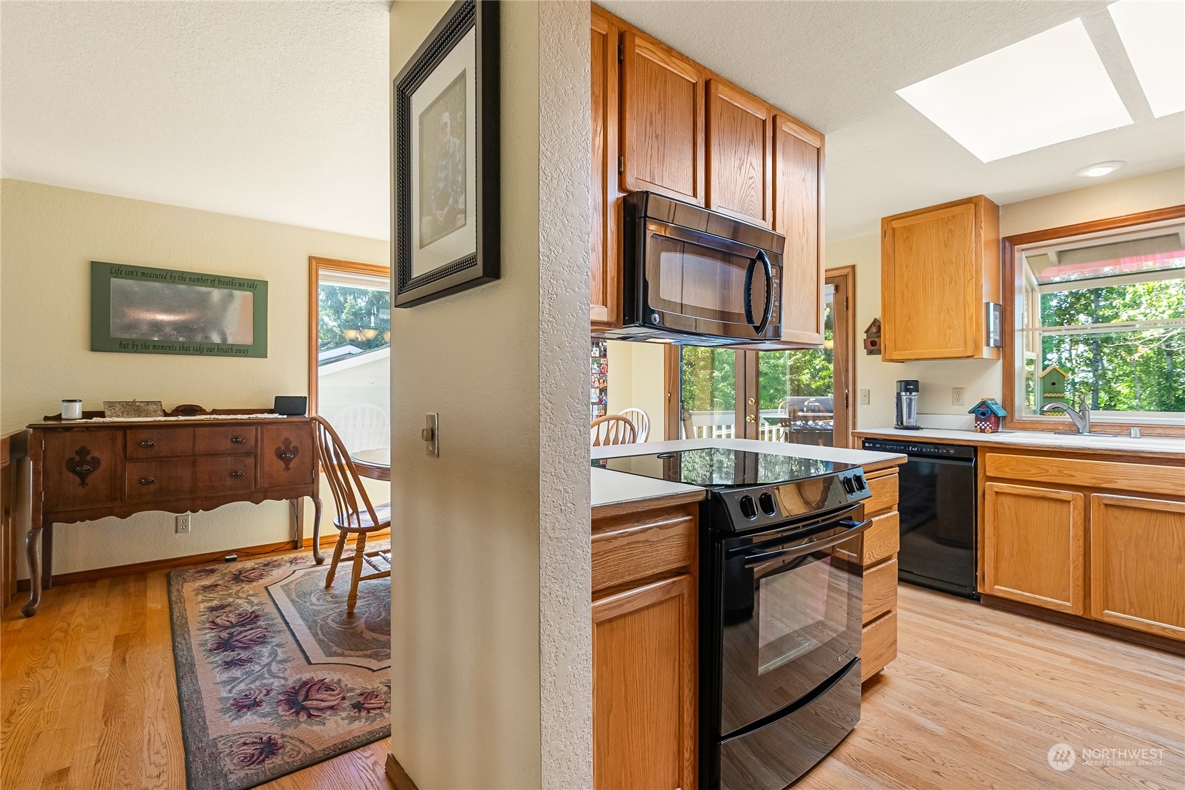 1388 Welling Road Bellingham, WA 98226 - Photo 10 of 40 a kitchen with stainless steel appliances granite countertop a stove a sink and a microwave