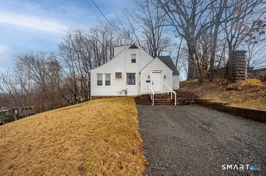 73 Silver Street Middletown, CT 06457 - Photo 1 of 30 a view of a house with a yard covered in snow