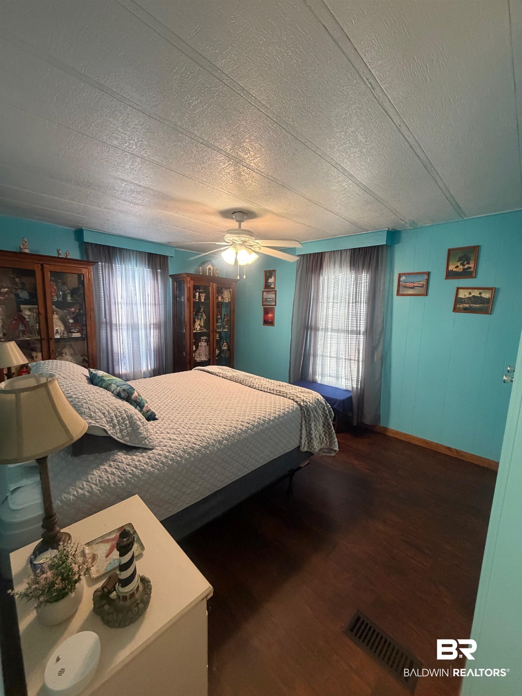 1430 Ridgewood Drive Lillian, AL 36549 - Photo 11 of 34 Bedroom with wood finished floors, a ceiling fan, and a textured ceiling