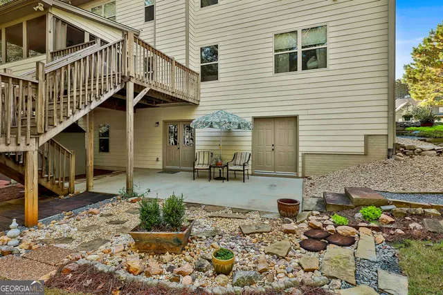 a roof deck with table and chairs