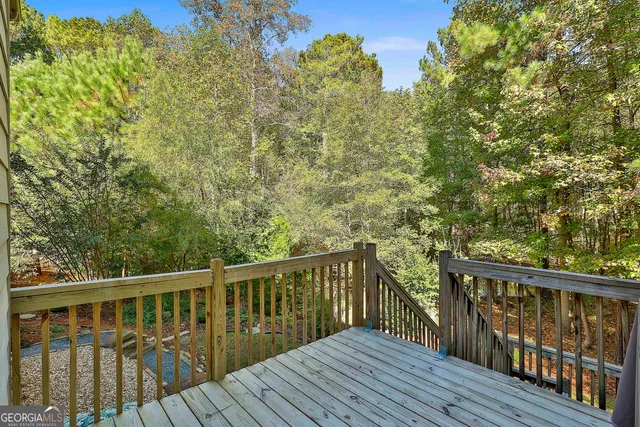 a balcony with wooden floor and outdoor space