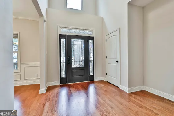 a view of an empty room with wooden floor