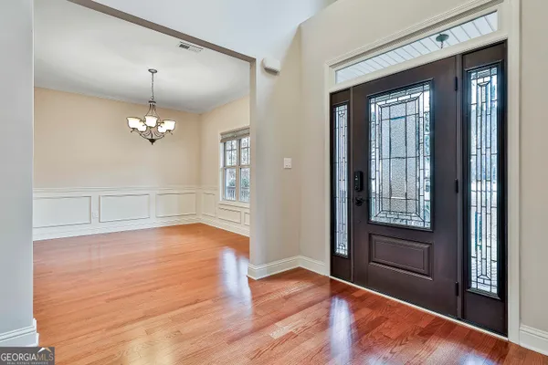 a view of a livingroom with a flat screen tv wooden floor and a fireplace