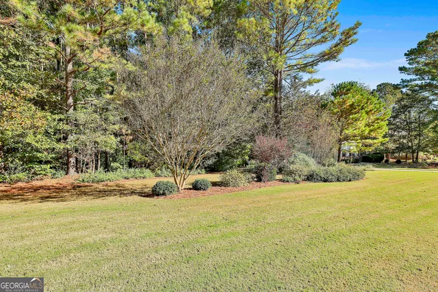 a view of yard with swimming pool and trees