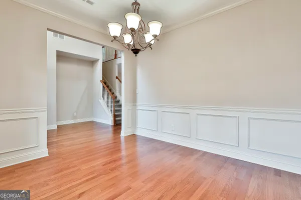 a kitchen with stainless steel appliances granite countertop a refrigerator a sink dishwasher a stove with wooden cabinets and floor