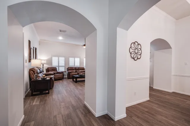 a living room with furniture and a wooden floor