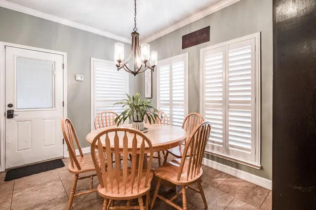 a view of a hallway with wooden floor and furniture