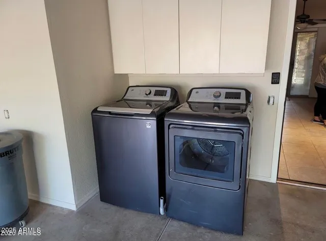 a view of washer and dryer with kitchen in the background