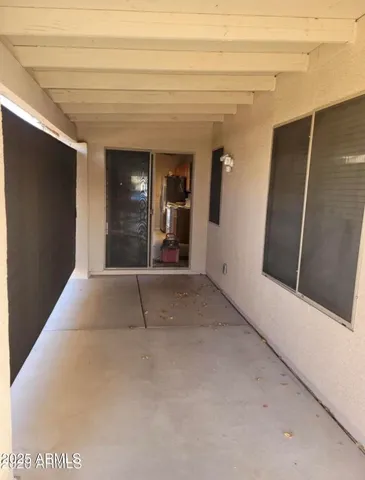 a view of a hallway with wooden floor and door