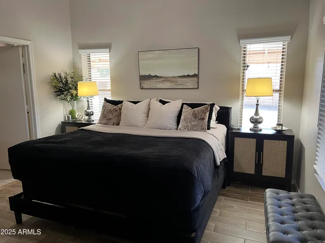 a bedroom with a bed and wooden floor