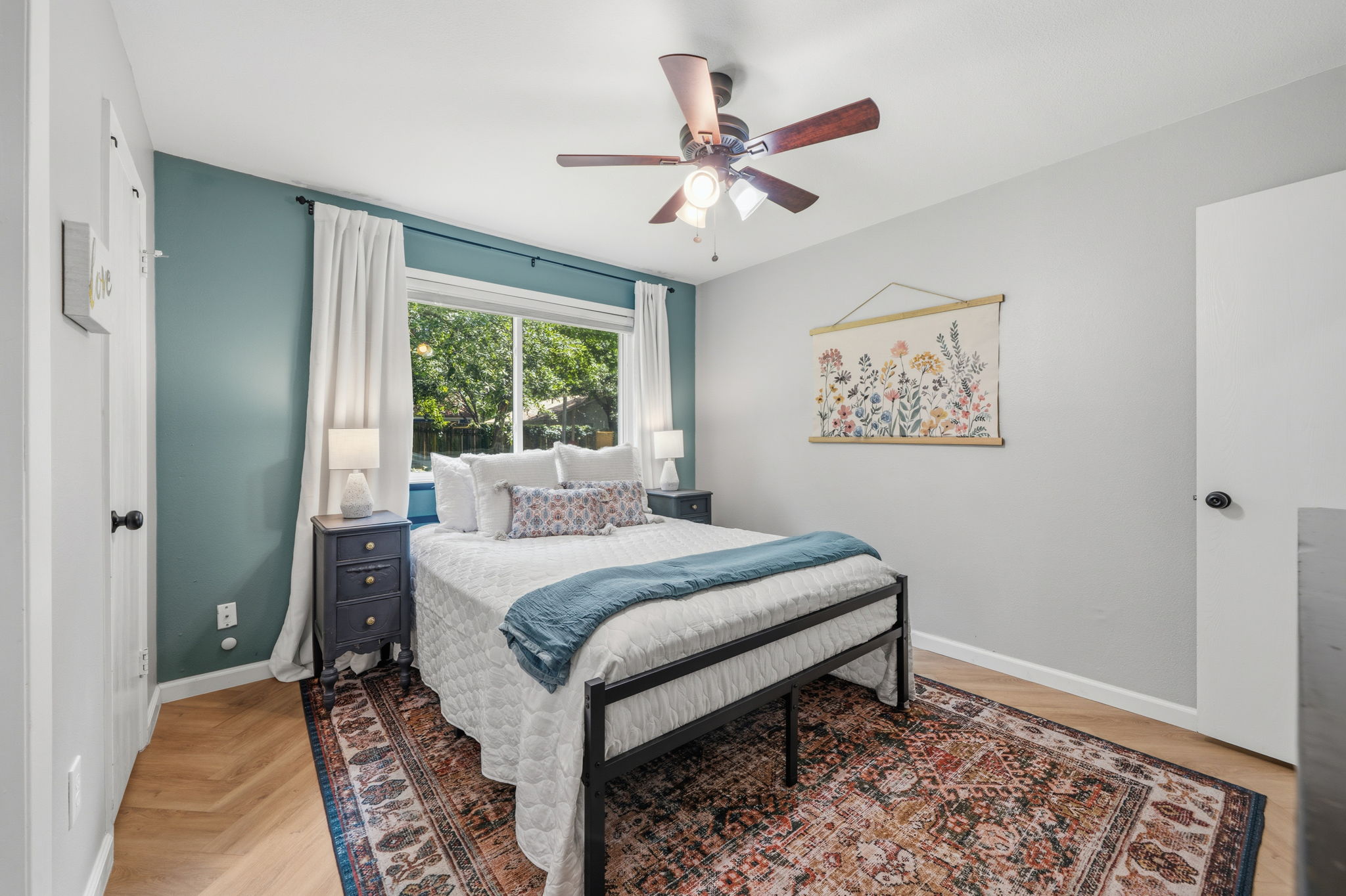 705 Dulwich Street Austin, TX 78748 - Photo 14 of 36 Well-lit sleeping quarters with rich hardwood flooring and a refreshing ceiling fan.