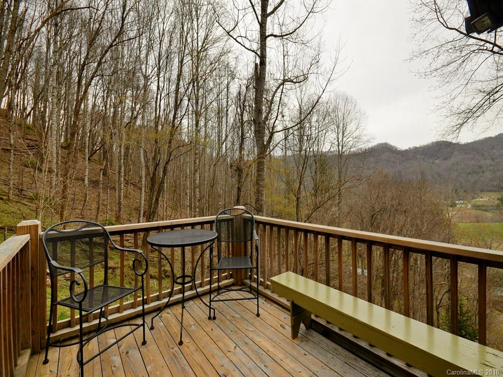 502 Sugar Cove Road Clyde, NC 28721 - Photo 14 of 24 a view of a roof deck with wooden floor and fence