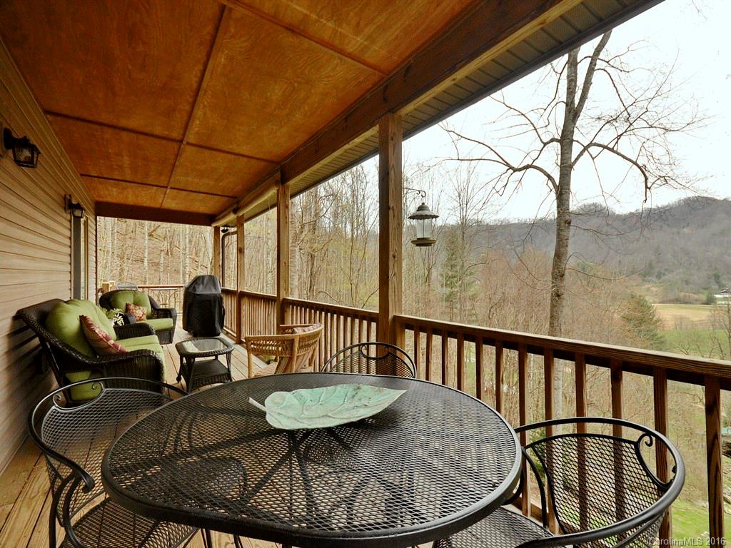 502 Sugar Cove Road Clyde, NC 28721 - Photo 15 of 24 a view of balcony with furniture and wooden floor