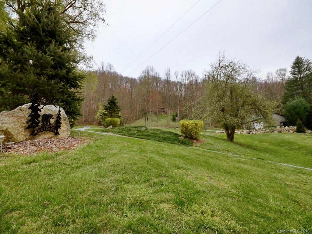502 Sugar Cove Road Clyde, NC 28721 - Photo 17 of 24 a view of a field with large trees