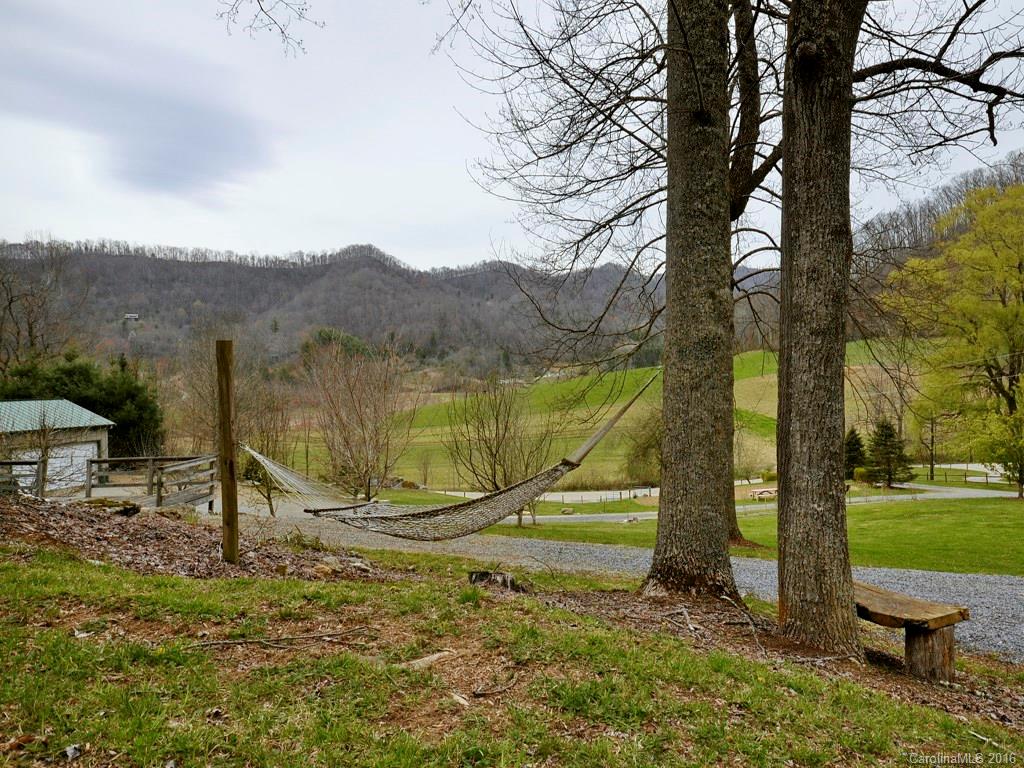 502 Sugar Cove Road Clyde, NC 28721 - Photo 22 of 24 a view of a lake with a mountain in the background